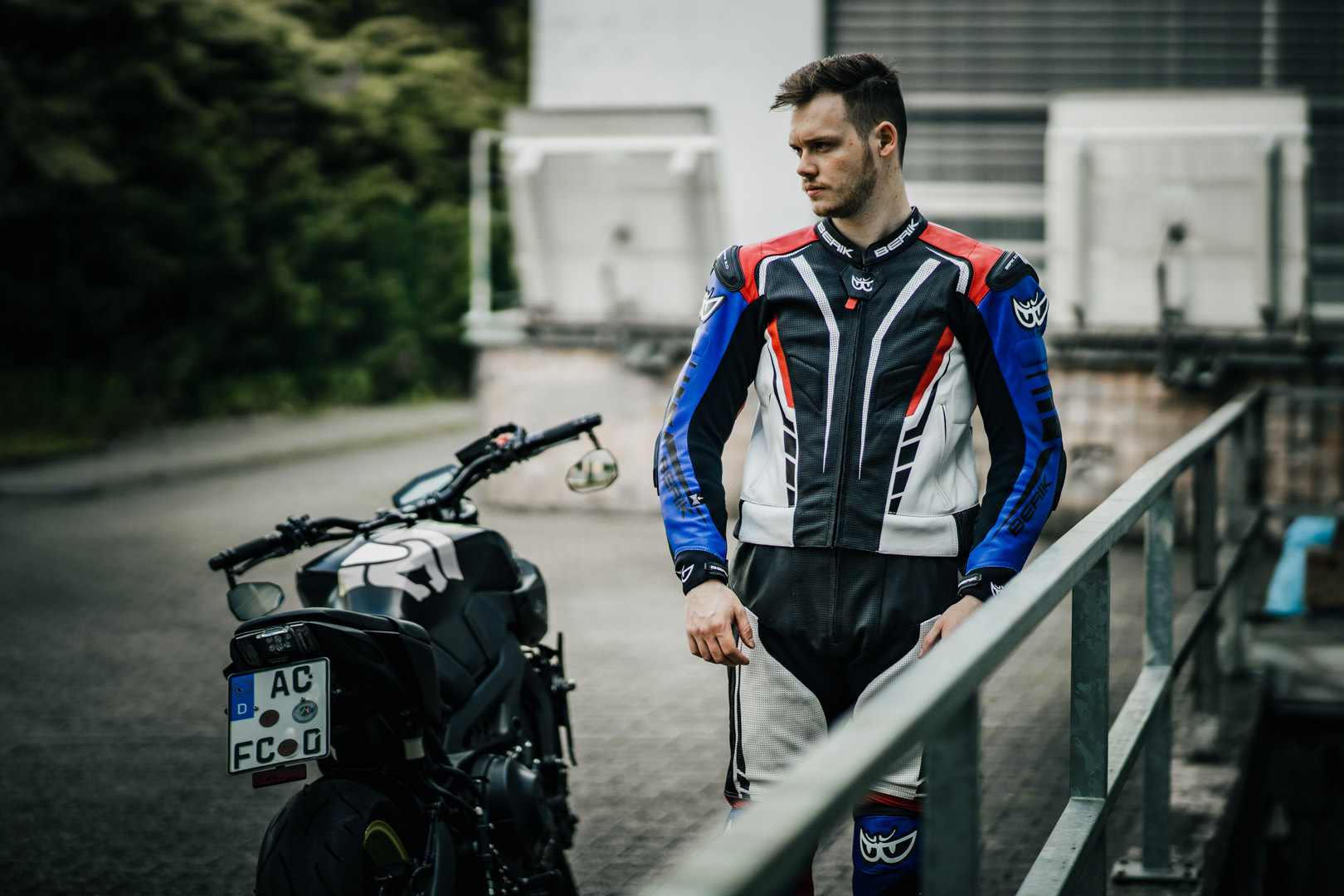 Side view of Berik XR-Ace Two Piece Motorcycle Leather Suit, black-white-red-blue, Size 52 for Men