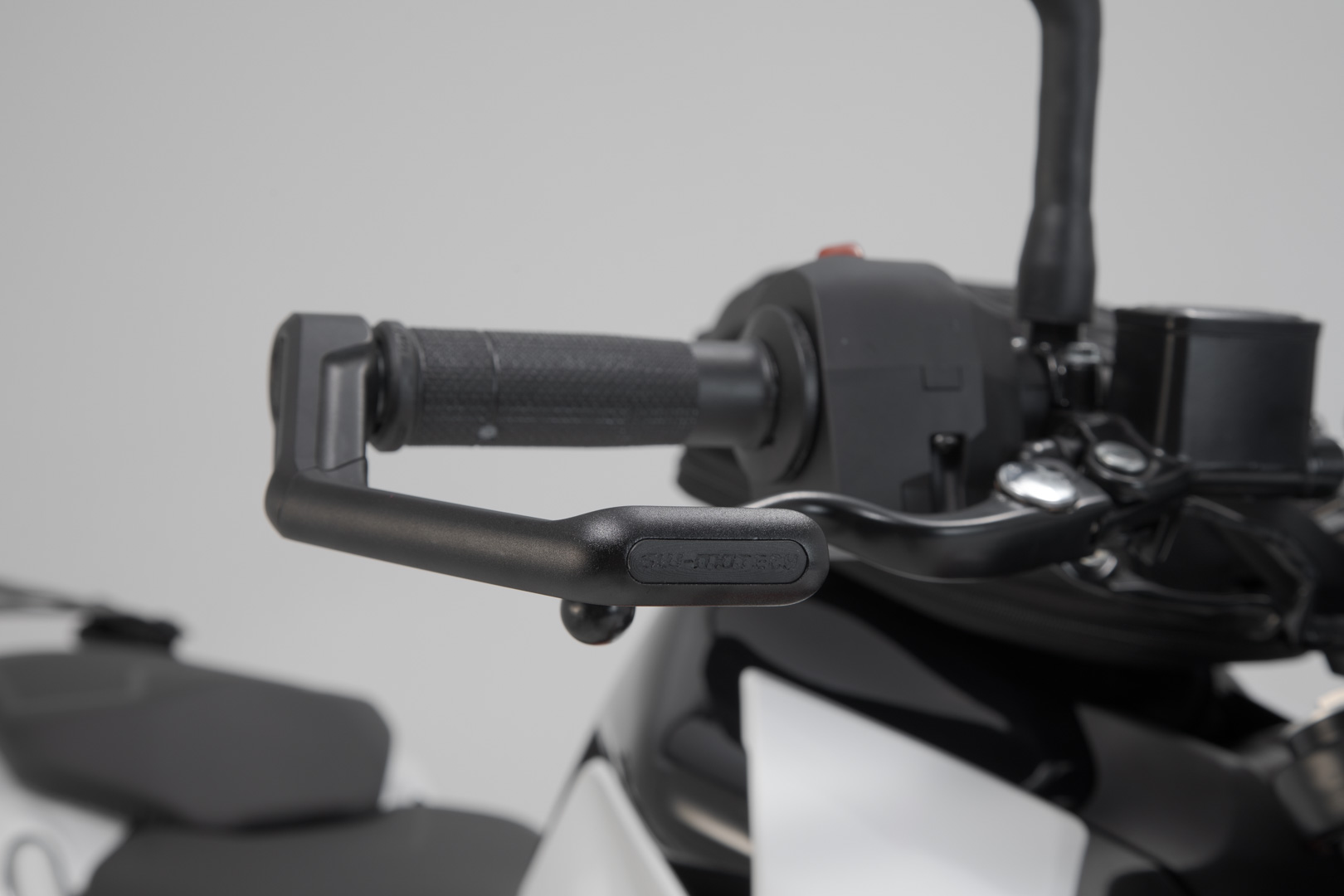 Side view of SW-Motech Lever guards - Black. Ducati / KTM / Aprilia / Honda / Yamaha.